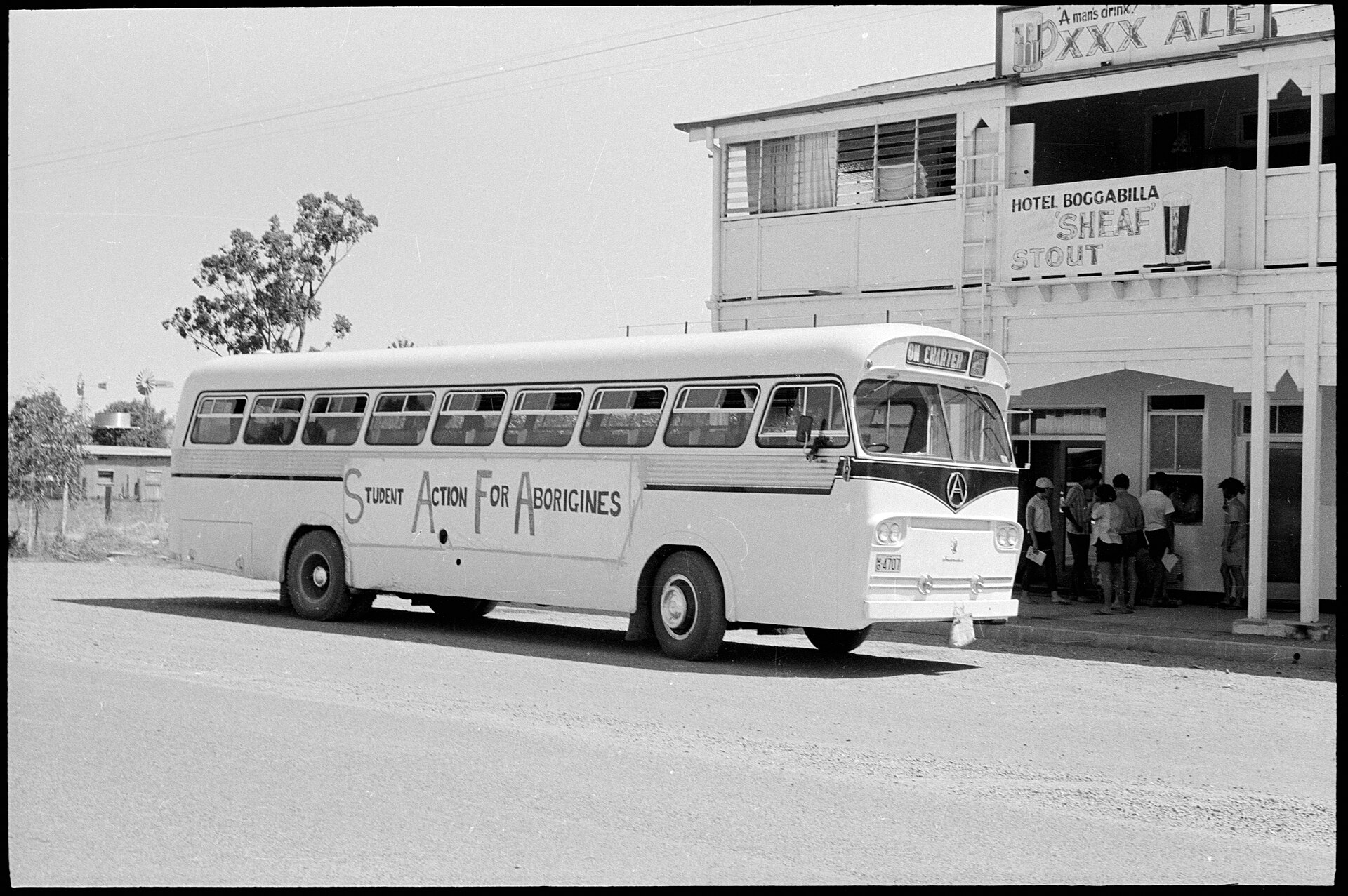 Student Action For Aboriginals (SAFA) bus outside hotel, Boggabilla, New South Wales, February 1965, by Noel Hazard, film negative, Mitchell Library, State Library of New South Wales and Courtesy SEARCH Foundation ON 161/220'ON 161/220